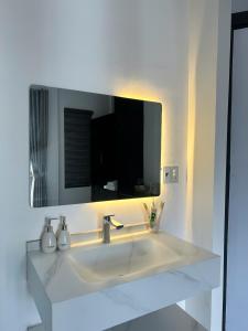 a bathroom sink with a large mirror above it at Cốm Homestay in Hue