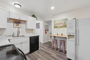 a kitchen with white cabinets and a counter top at Spacious 2BR Across from Como Lake - Bramble in Saint Paul