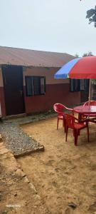 a picnic table and an umbrella in front of a house at Begnas horizon in Pokhara