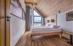 a bedroom with a bed in a room with a window at Beautiful Home In Ostrowite With Lake View in Ostrowite