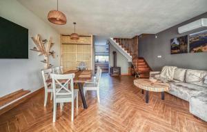 a living room with a couch and a table at Beautiful Home In Ostrowite With Lake View in Ostrowite
