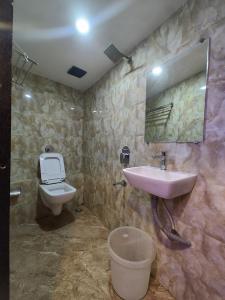 a bathroom with a sink and a toilet at Hotel Rio in Mumbai +12 photos
