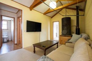 a living room with a couch and a coffee table at Kaha Lodge in Rangataua