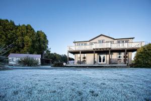 a large house with a large yard at Kaha Lodge in Rangataua