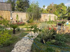a garden with plants and a fence at Hidden Valley Pai in Pai +14 photos