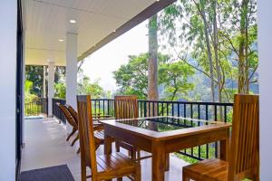 a porch with a table and chairs on a balcony at Ella Breathing Space in Ella
