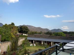 a view of a house with mountains in the background at Hidden Valley Pai in Pai
