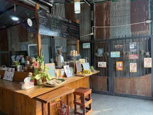 a restaurant with a counter with signs on it at Hidden Valley Pai in Pai