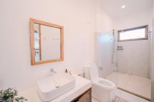 a bathroom with a sink and a toilet and a shower at Villa Ramira in General Luna +14 photos
