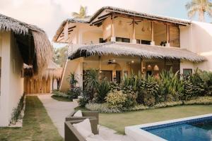 a house with a swimming pool in front of it at Villa Ramira in General Luna