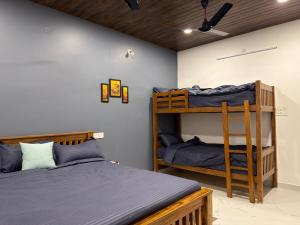 a bedroom with two bunk beds and a ceiling at Yelagiri castle in Yelagiri +18 photos