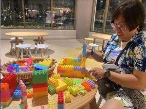 a woman playing with blocks on a table at Alma Resort - Căn hộ in Cam Lâm