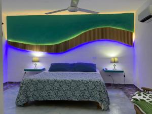 a bedroom with a bed and two tables with lamps at House Jardin Del Caribe in Las Terrenas +40 photos