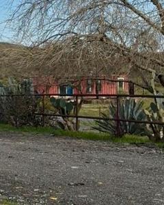 a fence with a house in the background at Private Ranch Retreat in Banning