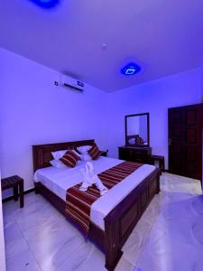 a bedroom with a large bed in a room at Air Port Ama Villa - Transit Getaway in Katunayaka