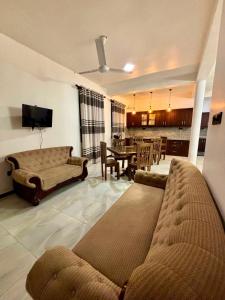 a living room with a couch and a dining room at Air Port Ama Villa - Transit Getaway in Katunayaka