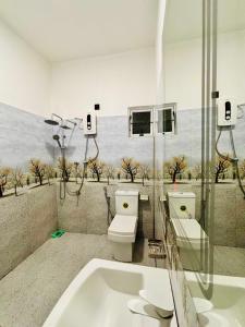 a bathroom with a toilet and a bath tub at Air Port Ama Villa - Transit Getaway in Katunayaka +45 photos