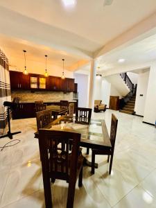 a dining room with a wooden table and chairs at Air Port Ama Villa - Transit Getaway in Katunayaka