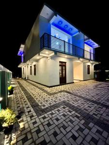 a large white building with a balcony at night at Air Port Ama Villa - Transit Getaway in Katunayaka