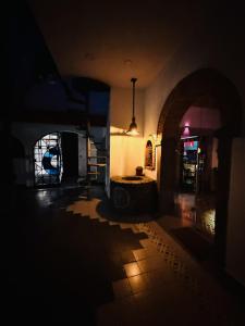 a dark room with a dark hallway with a pendant light at Macondo Hotel Galería in San Luis Potosí