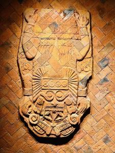 a carving of a person on a brick floor at Macondo Hotel Galería in San Luis Potosí