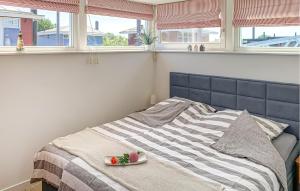 a bed with a plate of fruit on top of it at Maasvilla - Amfibie - 31 in Ohé en Laak +15 photos