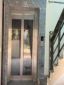a glass door in a building with a staircase at PLAY HOTEL BLU MOON couple friendly in Greater Noida