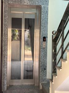 a glass door to a house with a staircase at PLAY HOTEL BLU MOON couple friendly in Greater Noida +20 photos