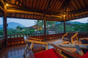 a balcony with chairs and a view of the mountains at Unik Cottage in Sidemen