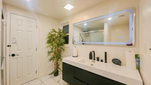a bathroom with a sink and a mirror at Seasun Hostel in Los Angeles +4 photos