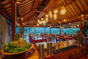 a restaurant with a bowl of fruit on a table at Unik Cottage in Sidemen