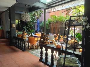 a restaurant with a table and chairs in a room at Hi Karon Beach in Karon Beach