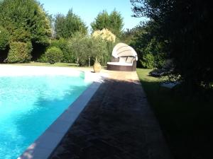 a large swimming pool with a spa in a yard at Casa la Quiete in Torgiano