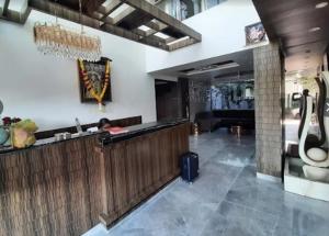 a lobby with a bar in a building at Hotel Paradise Ahilyanagar in Ahmadnagar