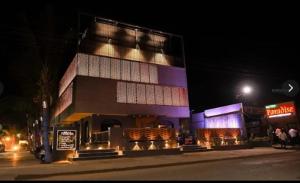 a building on the side of a street at night at Hotel Paradise Ahilyanagar in Ahmadnagar