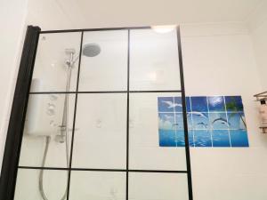 a shower in a bathroom with a glass door at 5 Overstone Drive in Wisbech +14 photos