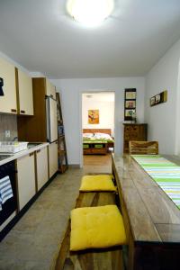 a kitchen with a wooden table and yellow cushions at Appartement Veronika in Öblarn