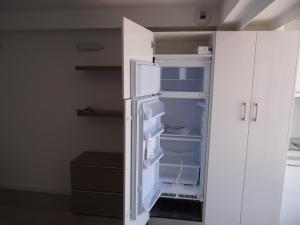 an empty refrigerator with its door open in a room at Les pieds dans la mer Best place in Villefranche-sur-Mer