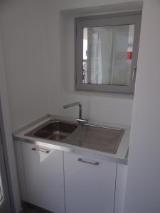 a kitchen with a sink and a mirror at Les pieds dans la mer Best place in Villefranche-sur-Mer