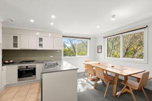 a kitchen and dining room with a table and chairs at Three Bears 3 - Thredbo in Thredbo