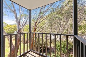 a balcony with a view of a tree at Three Bears 3 - Thredbo in Thredbo