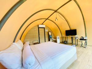 a large bed in a room with an archway at Azana Essence Selo Boyolali in Boyolali