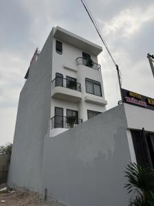 a white building with balconies on the side of it at Hotel Trần Anh in Xóm Bên Ðông