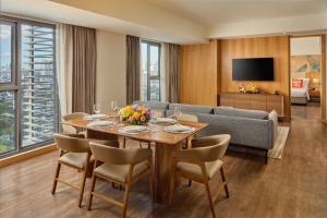 a living room with a table and a couch at Alino Hotel in Manila