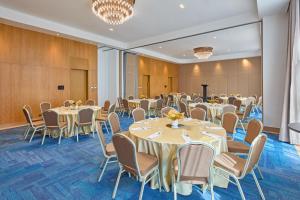 a conference room with tables and chairs and a podium at Alino Hotel in Manila