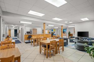 an office with tables and chairs and a couch at Days Inn by Wyndham Imlay City in Imlay City