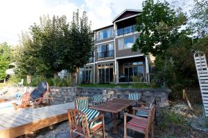 a patio with a table and chairs in front of a building at OKeefes Landing Bed & Breakfast in Vernon