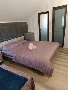 a bedroom with a bed with a towel on it at Rose house in Constanţa