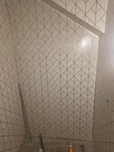 a white tiled ceiling with a diamond pattern on it at Rose house in Constanţa
