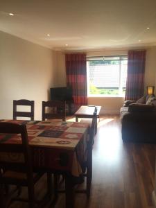 a living room with a table and a couch at An Teallach in Oban